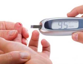 Mother is doing glucose level finger blood test to child